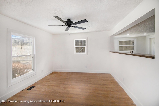 625 W Jefferson St, Grand Ledge, MI 48837 - unfurnished room featuring a textured ceiling, wood finished floors, ceiling fan, and recessed lighting