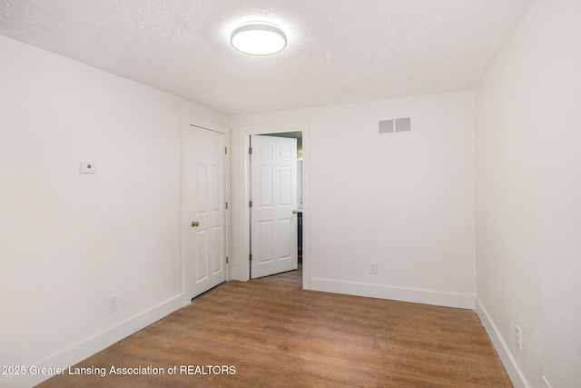 625 W Jefferson St, Grand Ledge, MI 48837 - unfurnished room with wood finished floors and a textured ceiling
