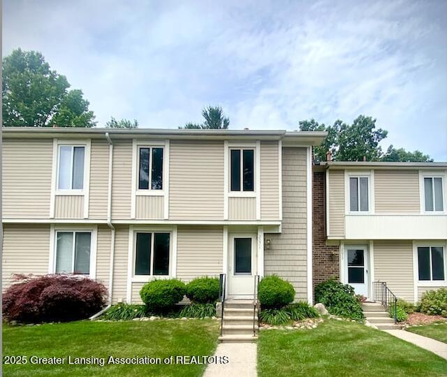 2071 Lac Du Mont, Haslett, MI 48840 - townhome / multi-family property with a front lawn