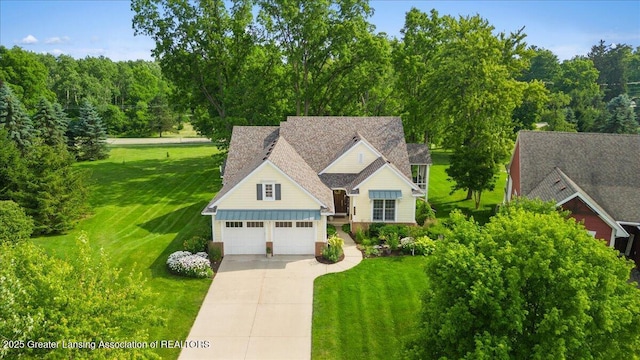 3537 Winborn Dr, Dewitt, MI 48820 - view of front facade with driveway, a front yard, and a garage