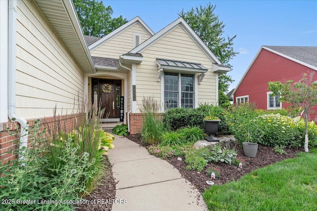 3537 Winborn Dr, Dewitt, MI 48820 - view of exterior entry with brick siding and roof with shingles