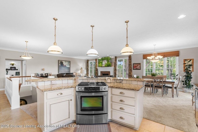 3537 Winborn Dr, Dewitt, MI 48820 - kitchen featuring stainless steel gas range oven, ornamental molding, healthy amount of natural light, open floor plan, and a fireplace
