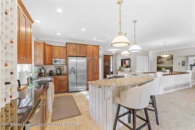 3537 Winborn Dr, Dewitt, MI 48820 - kitchen with stainless steel fridge, crown molding, brown cabinets, a breakfast bar area, and pendant lighting