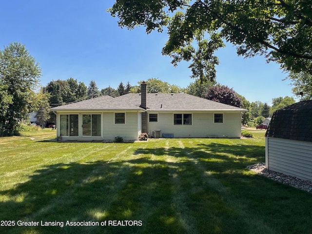 6716 Bunker Hill Dr, Lansing, MI 48906 - back of property with a yard and a storage unit