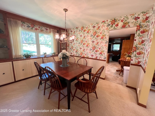 6716 Bunker Hill Dr, Lansing, MI 48906 - dining area with wallpapered walls, a wainscoted wall, and a chandelier
