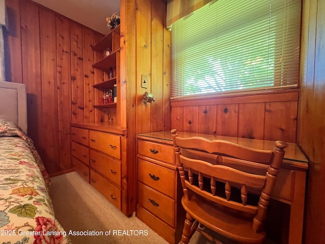 6716 Bunker Hill Dr, Lansing, MI 48906 - bedroom featuring wood walls and light colored carpet