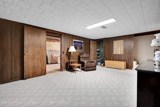 6716 Bunker Hill Dr, Lansing, MI 48906 - living area featuring wooden walls and carpet