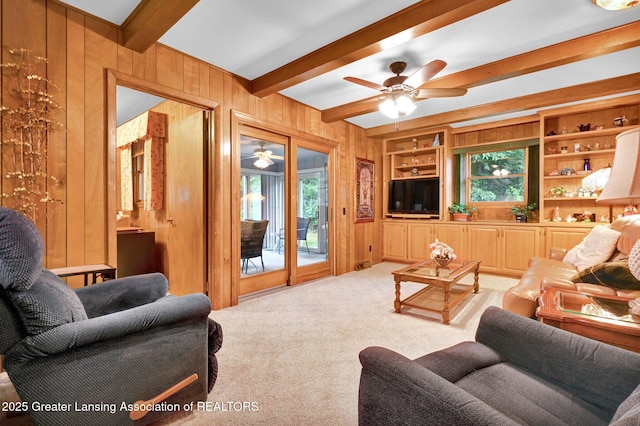6716 Bunker Hill Dr, Lansing, MI 48906 - carpeted living area with wooden walls, beamed ceiling, and a ceiling fan