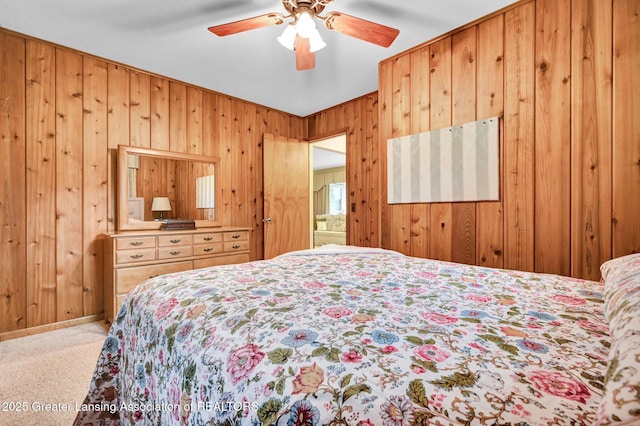6716 Bunker Hill Dr, Lansing, MI 48906 - bedroom with wood walls, carpet floors, and a ceiling fan