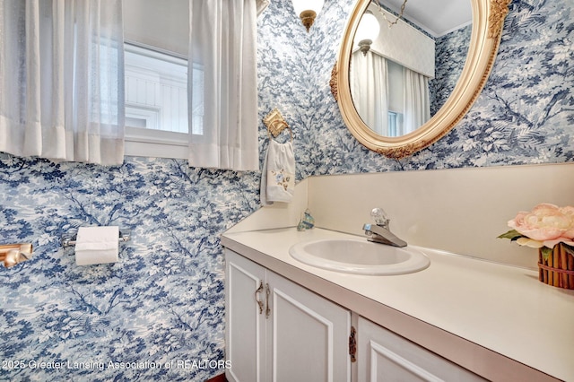 6716 Bunker Hill Dr, Lansing, MI 48906 - bathroom featuring wallpapered walls and vanity
