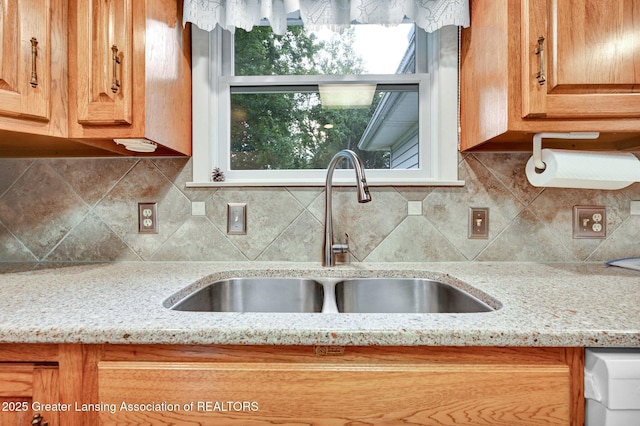 6716 Bunker Hill Dr, Lansing, MI 48906 - kitchen featuring light stone countertops and decorative backsplash