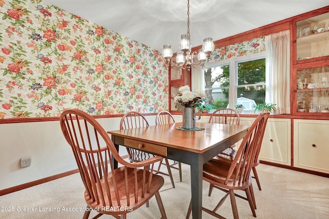 6716 Bunker Hill Dr, Lansing, MI 48906 - dining room featuring wallpapered walls, wainscoting, a chandelier, and light colored carpet