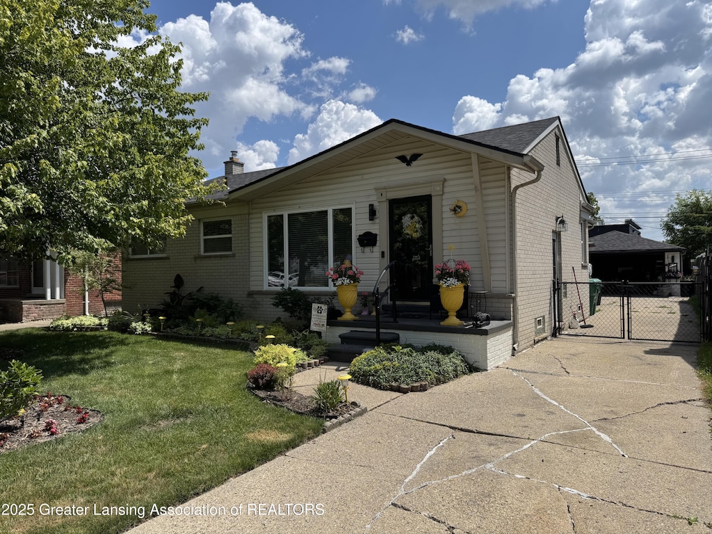 816 Arcola St, Garden City, MI 48135 - view of front of home with brick siding, a gate, a chimney, and concrete driveway