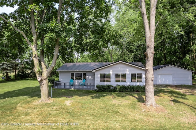1337 Shepard St, Crystal, MI 48818 - view of front of house with a garage, an outbuilding, a front lawn, a deck, and a metal roof