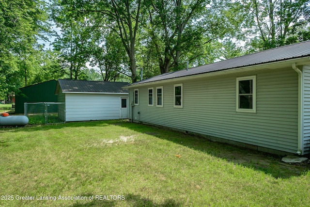 1337 Shepard St, Crystal, MI 48818 - rear view of house featuring a metal roof and a lawn