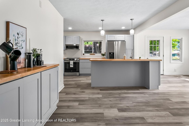 1337 Shepard St, Crystal, MI 48818 - kitchen featuring wood counters, stainless steel appliances, recessed lighting, light wood finished floors, and decorative light fixtures