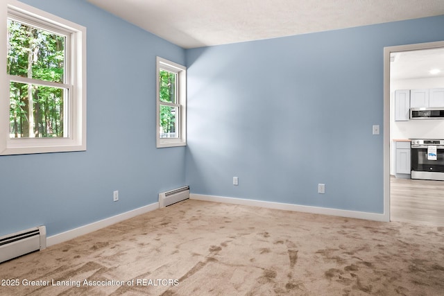 1337 Shepard St, Crystal, MI 48818 - empty room featuring baseboard heating and light carpet