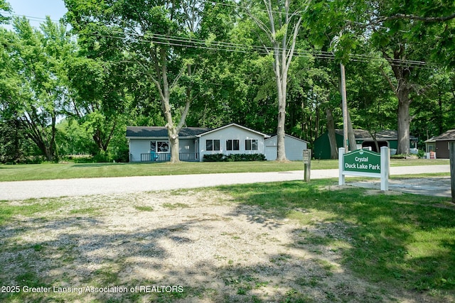 1337 Shepard St, Crystal, MI 48818 - ranch-style house with a front yard and view of wooded area