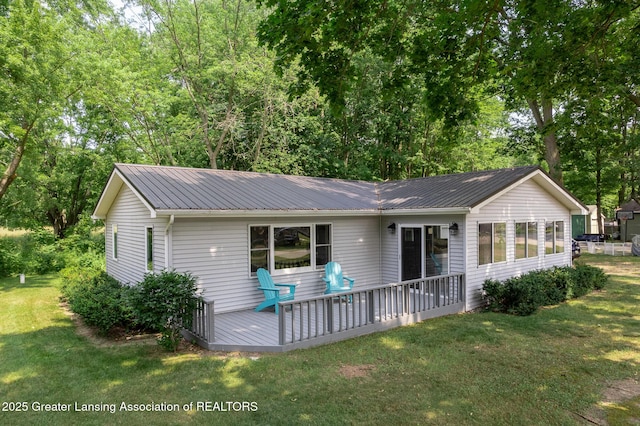 1337 Shepard St, Crystal, MI 48818 - rear view of property with a wooden deck, a yard, and a metal roof