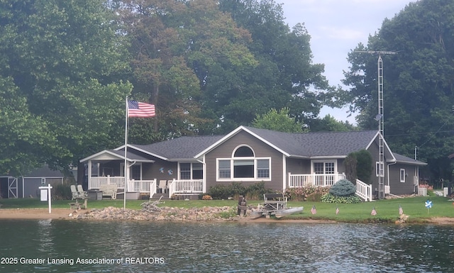 4813 Lakeside Dr, Perrinton, MI 48871 - back of property with a yard and a deck with water view