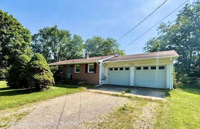 1214 Otto Rd Unit R1, Charlotte, MI 48813 - single story home featuring driveway, a chimney, a garage, a front lawn, and brick siding