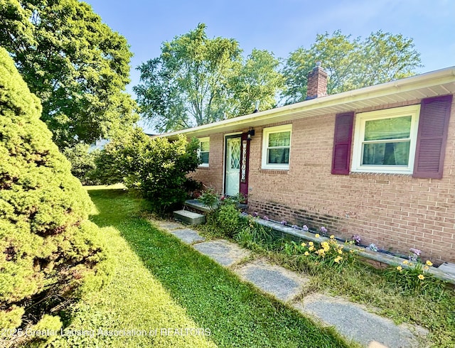 1214 Otto Rd Unit R1, Charlotte, MI 48813 - view of front of property featuring brick siding and a chimney
