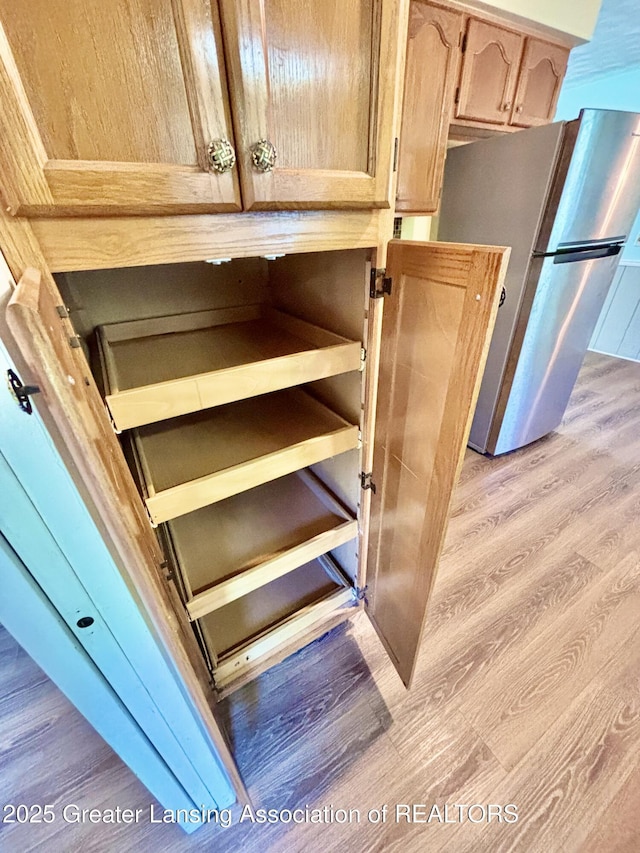 1214 Otto Rd Unit R1, Charlotte, MI 48813 - kitchen view of freestanding refrigerator, light wood-type flooring, and light brown cabinetry