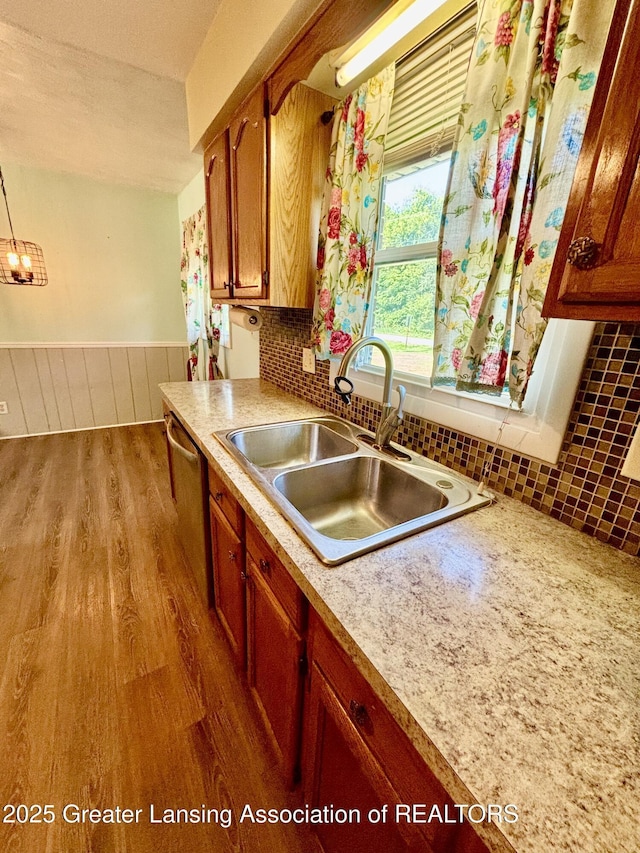 1214 Otto Rd Unit R1, Charlotte, MI 48813 - kitchen featuring dishwasher, wood finished floors, light countertops, brown cabinets, and backsplash