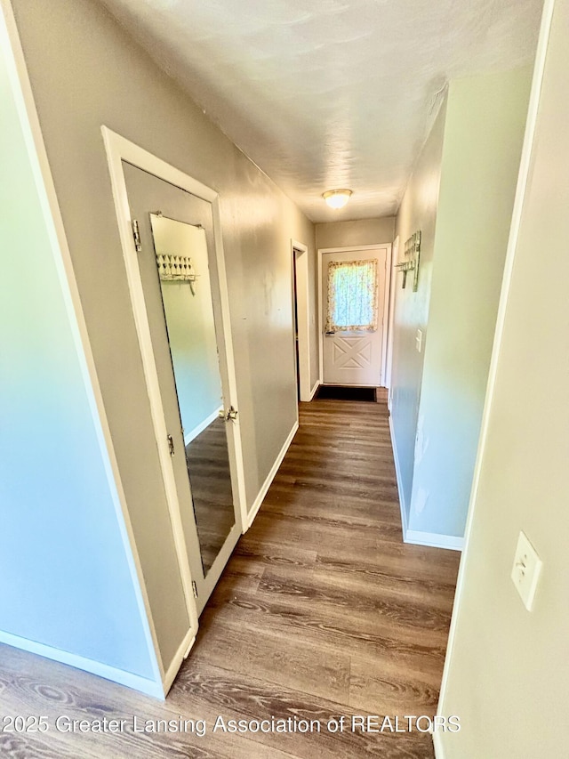 1214 Otto Rd Unit R1, Charlotte, MI 48813 - hallway featuring wood finished floors and baseboards