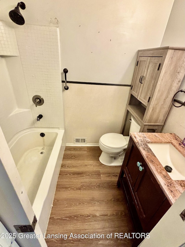 1214 Otto Rd Unit R1, Charlotte, MI 48813 - bathroom featuring vanity, wood finished floors, and bathing tub / shower combination