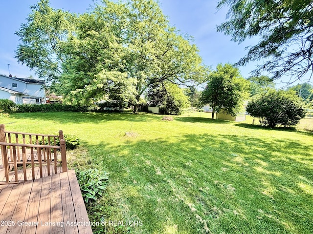 1214 Otto Rd Unit R1, Charlotte, MI 48813 - view of yard featuring a deck