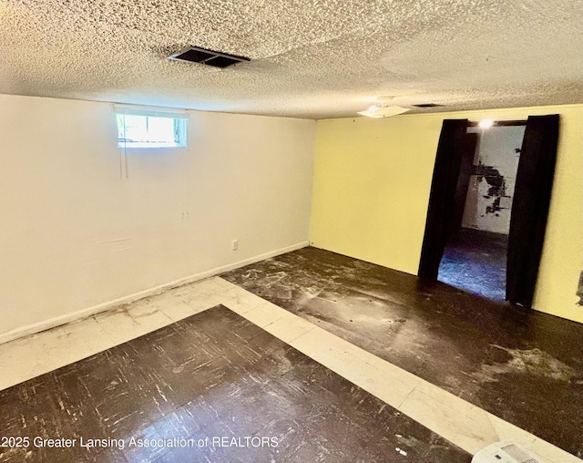 1214 Otto Rd Unit R1, Charlotte, MI 48813 - below grade area with a textured ceiling and baseboards