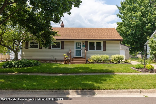 1220 Seymour St, Grand Ledge, MI 48837 - ranch-style house featuring a chimney, a front yard, a garage, and a shingled roof