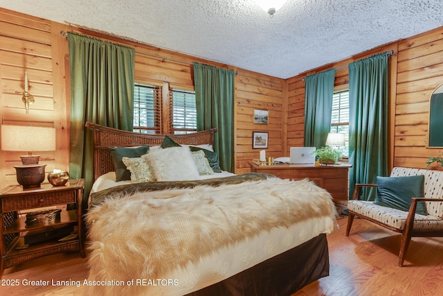 3536 N Royston Rd, Potterville, MI 48876 - bedroom featuring wood finished floors, a textured ceiling, and wood walls
