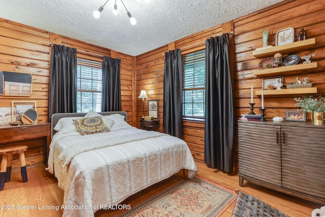3536 N Royston Rd, Potterville, MI 48876 - bedroom with light wood-style floors and a textured ceiling