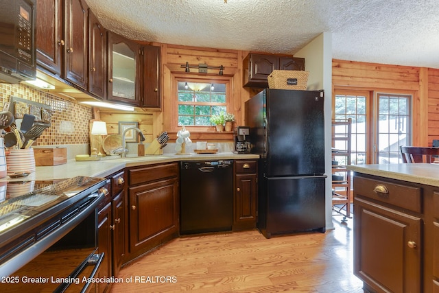 3536 N Royston Rd, Potterville, MI 48876 - kitchen with black appliances, plenty of natural light, light countertops, light wood-type flooring, and a textured ceiling