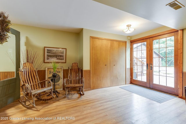 3536 N Royston Rd, Potterville, MI 48876 - foyer entrance featuring french doors, wood finished floors, and wainscoting