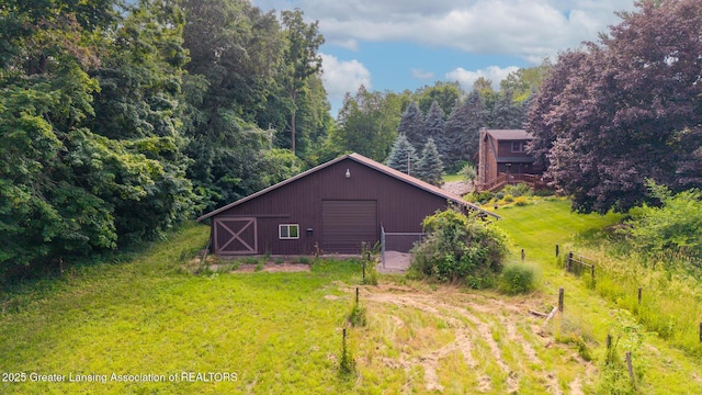 3536 N Royston Rd, Potterville, MI 48876 - rear view of property featuring an outbuilding, a detached garage, and an outdoor structure