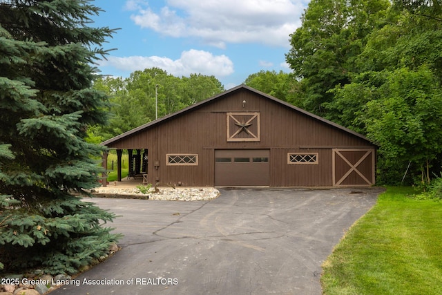 3536 N Royston Rd, Potterville, MI 48876 - view of front of house with a detached garage, a barn, an outbuilding, and driveway
