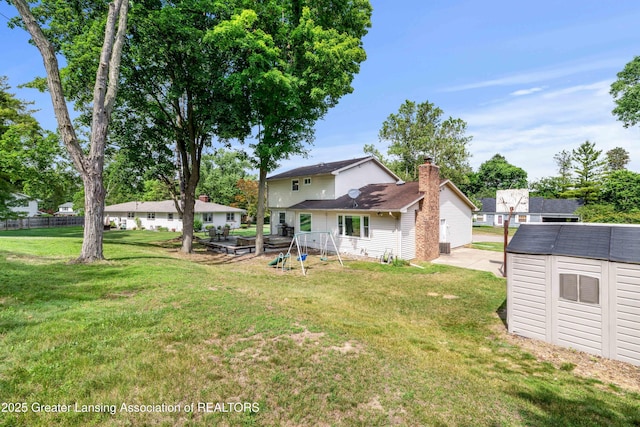 4629 Grandwoods Dr, Lansing, MI 48917 - view of grassy yard with a storage shed and a patio area