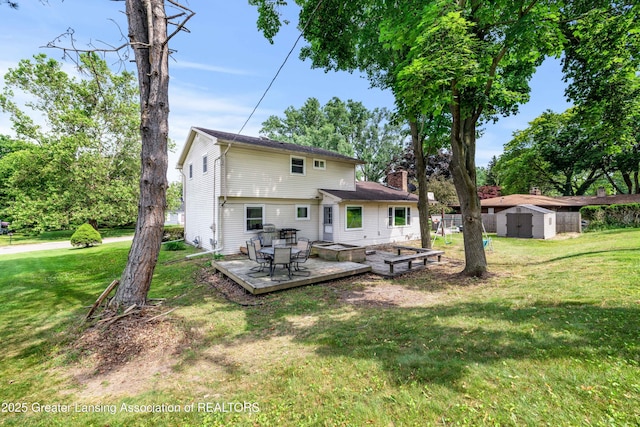 4629 Grandwoods Dr, Lansing, MI 48917 - back of house with a chimney, a shed, and a yard