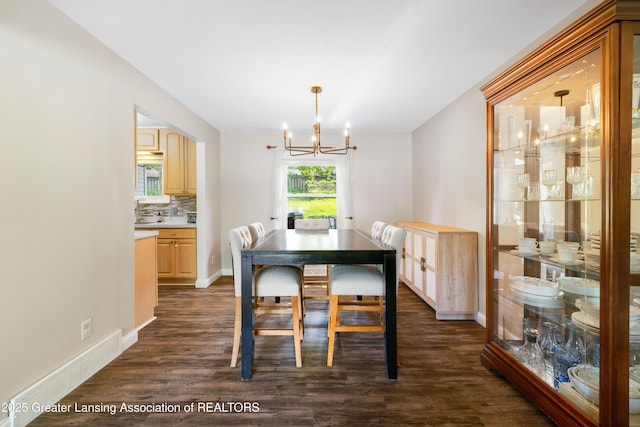 4629 Grandwoods Dr, Lansing, MI 48917 - dining area featuring a chandelier and dark wood-style floors