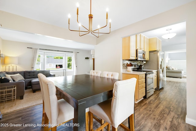 4629 Grandwoods Dr, Lansing, MI 48917 - dining area featuring dark wood-style floors and a chandelier