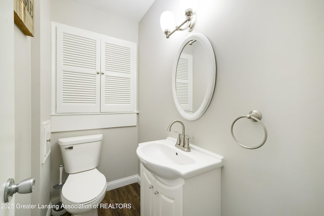 4629 Grandwoods Dr, Lansing, MI 48917 - half bath with vanity and wood finished floors
