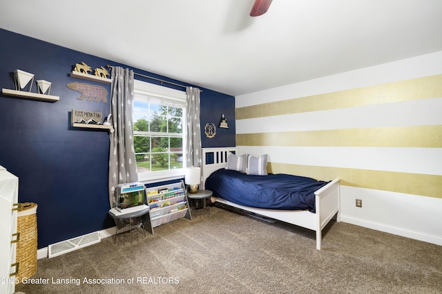 4629 Grandwoods Dr, Lansing, MI 48917 - carpeted bedroom with baseboards and a ceiling fan