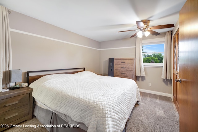 4629 Grandwoods Dr, Lansing, MI 48917 - carpeted bedroom with baseboards and a ceiling fan