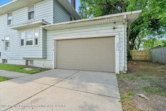 700 S Pennsylvania Ave, Lansing, MI 48912 - view of side of property featuring concrete driveway and an attached garage