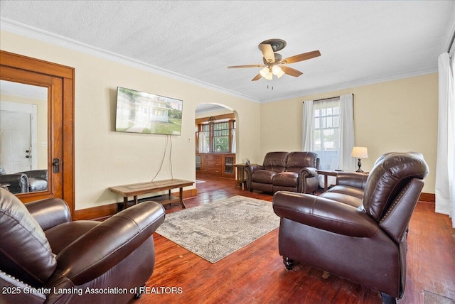 700 S Pennsylvania Ave, Lansing, MI 48912 - living room featuring arched walkways, ceiling fan, wood finished floors, and ornamental molding