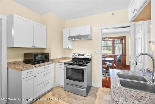 700 S Pennsylvania Ave, Lansing, MI 48912 - kitchen with electric stove, black microwave, under cabinet range hood, and white cabinets
