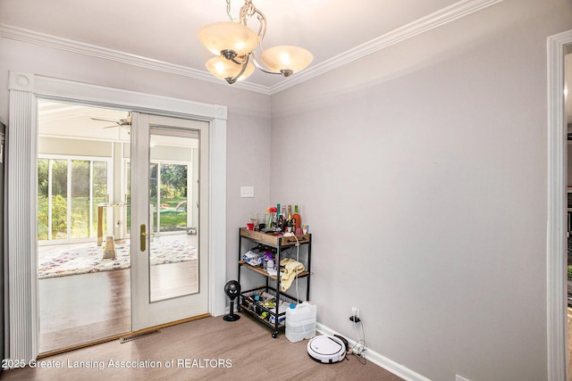 4326 Manitou Dr, Okemos, MI 48864 - entryway with crown molding, french doors, a chandelier, and a ceiling fan